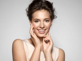Portrait of a blonde smiling young pretty woman with natural make-up