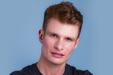 male with acne scars on a blue background